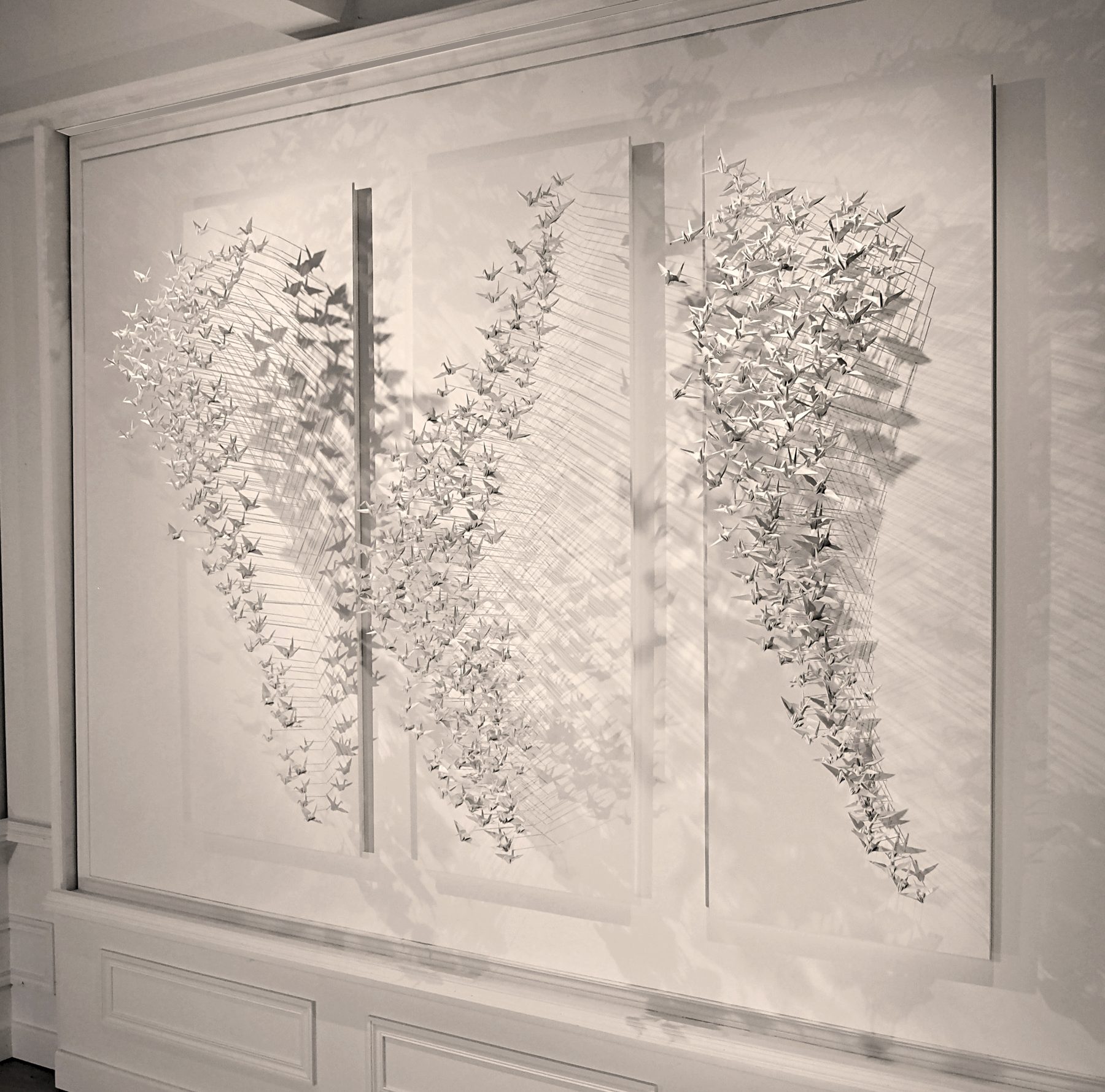Murmuration 33, triptych: three panels of white paper cranes.