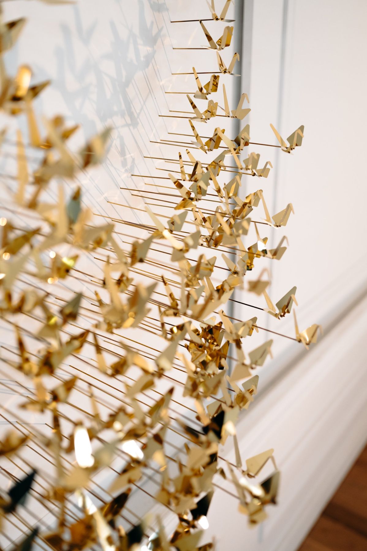 Brass cranes on their rods, in three-quarter view.