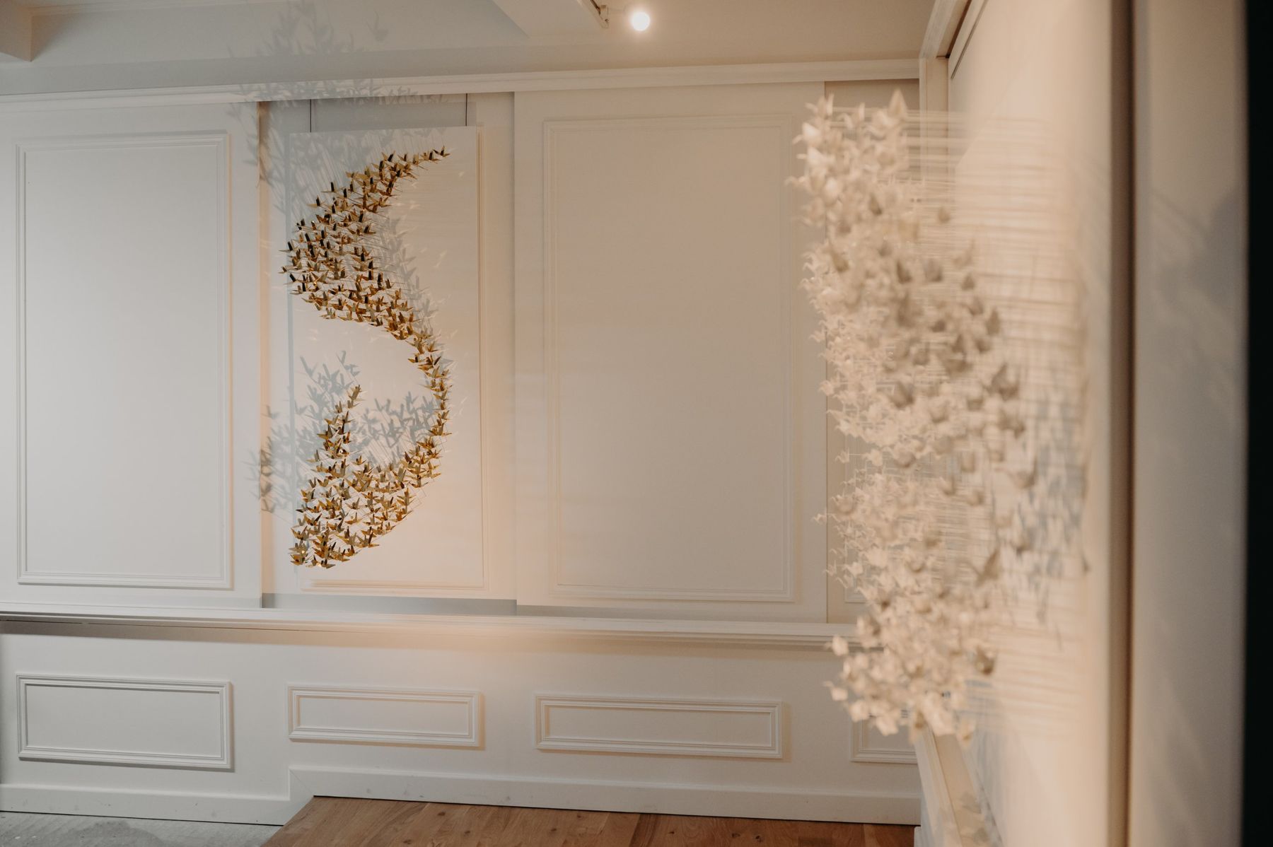 A brass Murmuration on the wall, a paper Murmuration in the foreground.